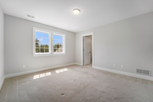 empty room featuring light carpet