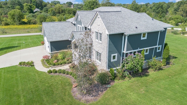 view of side of property featuring a lawn and a garage