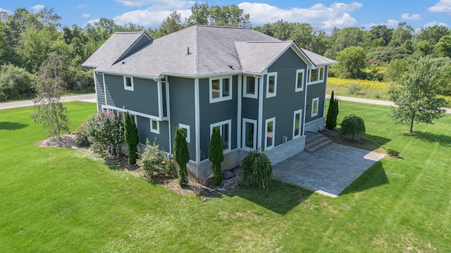 back of property featuring a yard and a patio