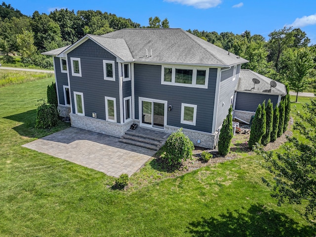 rear view of house with a yard and a patio area