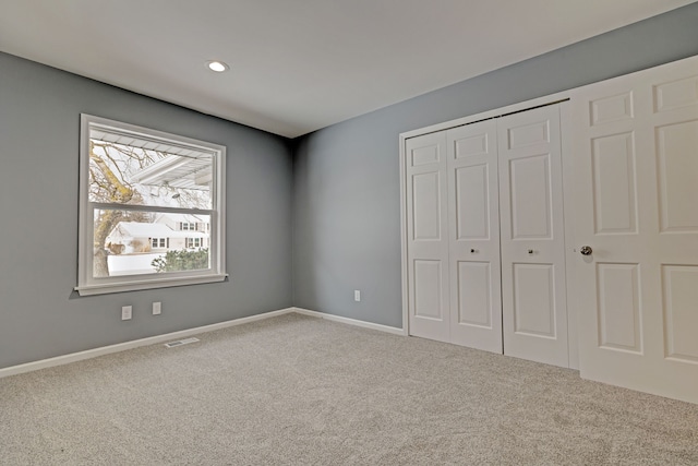 unfurnished bedroom featuring carpet floors and a closet