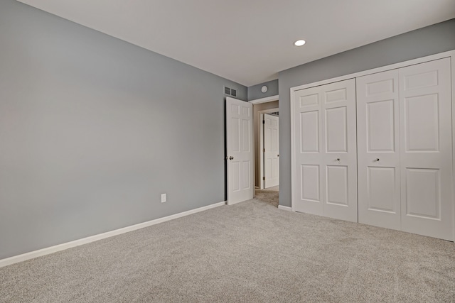 unfurnished bedroom featuring carpet floors and a closet