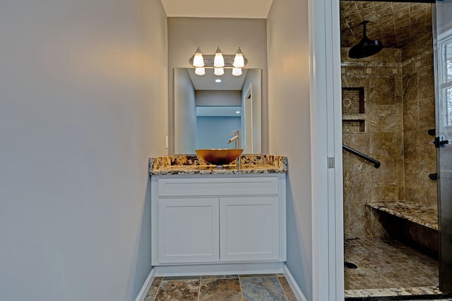 bathroom featuring vanity and tiled shower