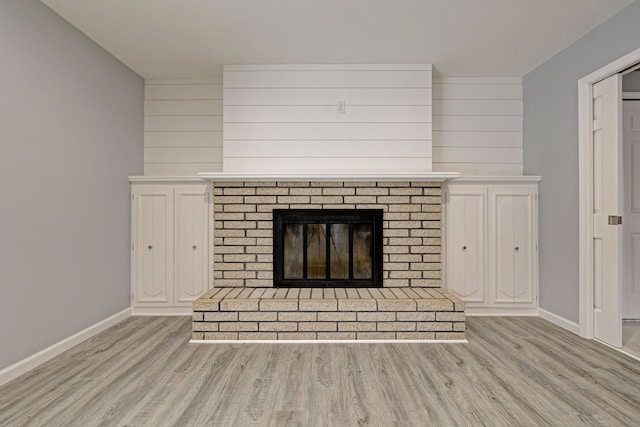 interior details with hardwood / wood-style floors and a brick fireplace