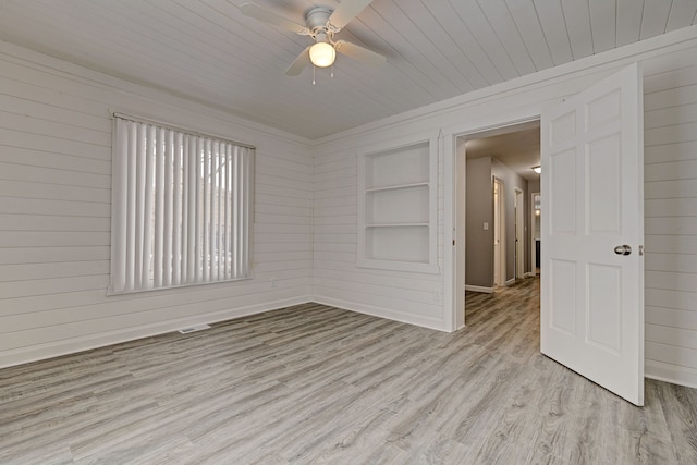 unfurnished room with light hardwood / wood-style flooring, built in features, ceiling fan, and wood ceiling