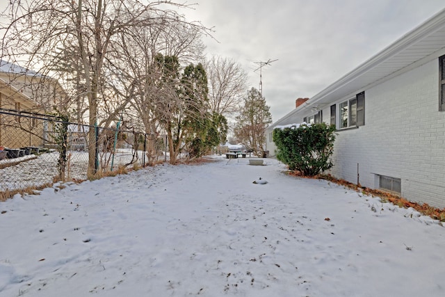 view of yard layered in snow