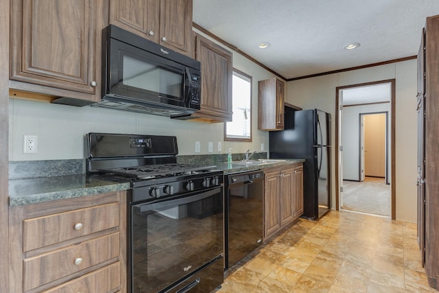 kitchen with a textured ceiling, ornamental molding, black appliances, a sink, and dark countertops
