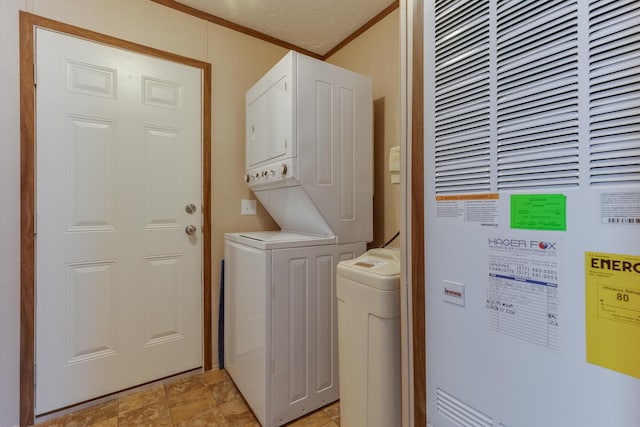 laundry room with crown molding, laundry area, a heating unit, and stacked washer / drying machine