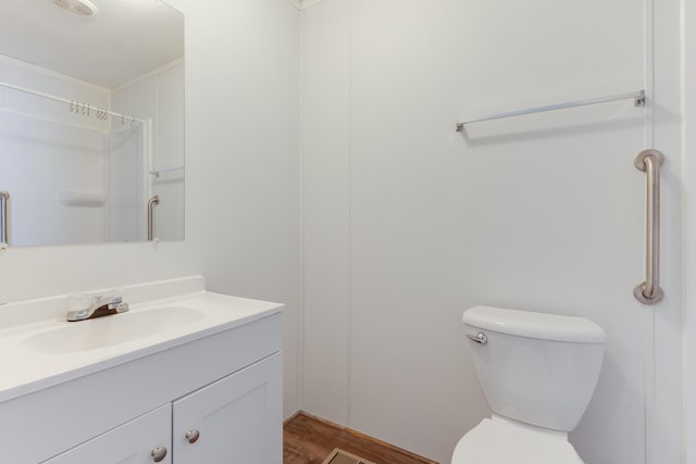 bathroom featuring vanity, toilet, and wood finished floors