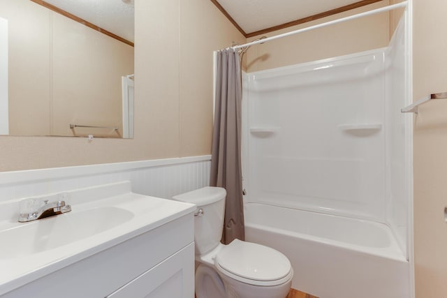 full bath featuring toilet, shower / tub combo with curtain, a textured ceiling, vanity, and wainscoting