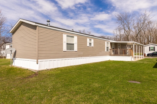 rear view of property featuring a lawn