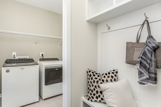 laundry area with light tile patterned flooring and independent washer and dryer