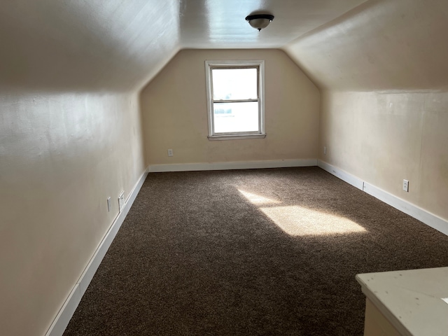 bonus room featuring lofted ceiling and carpet