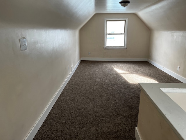 bonus room featuring lofted ceiling and carpet flooring