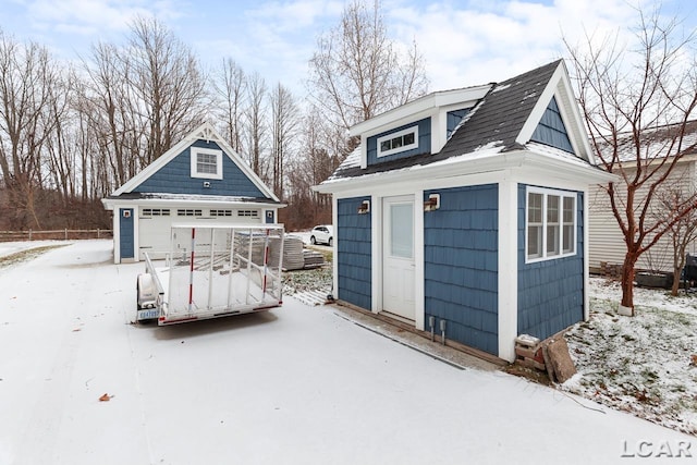 snow covered structure featuring a garage