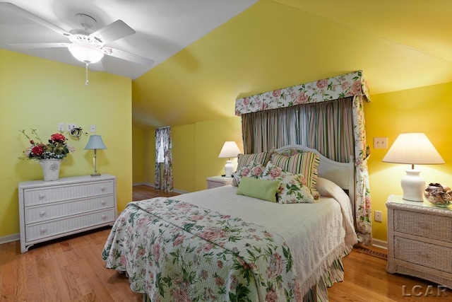 bedroom featuring ceiling fan, wood-type flooring, and vaulted ceiling