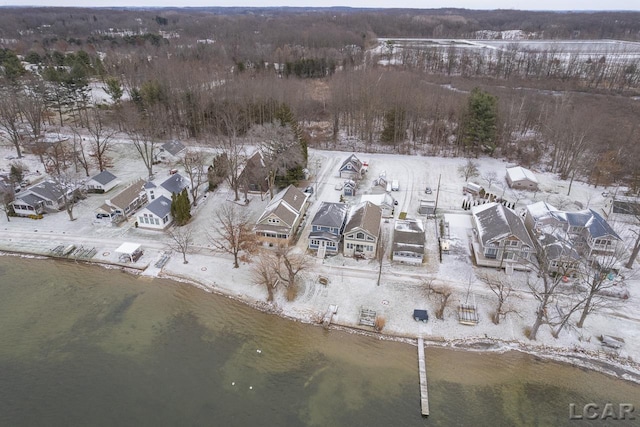 snowy aerial view featuring a water view