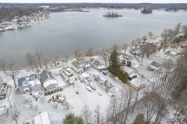 snowy aerial view with a water view