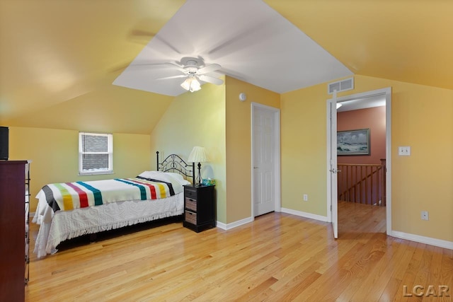 bedroom featuring light hardwood / wood-style floors, ceiling fan, and lofted ceiling