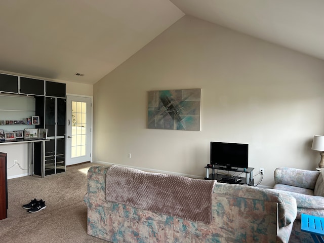 carpeted living room featuring vaulted ceiling