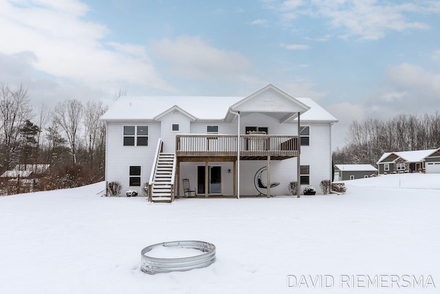 snow covered property featuring a wooden deck