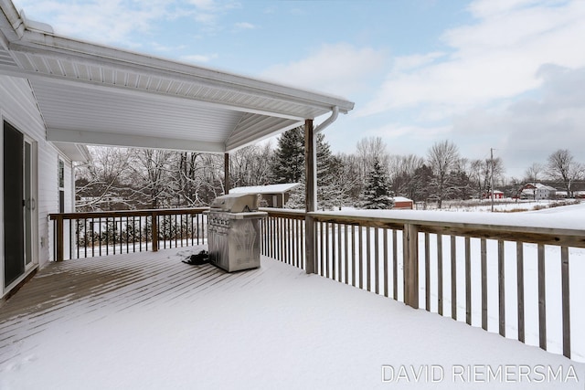 snow covered deck with area for grilling