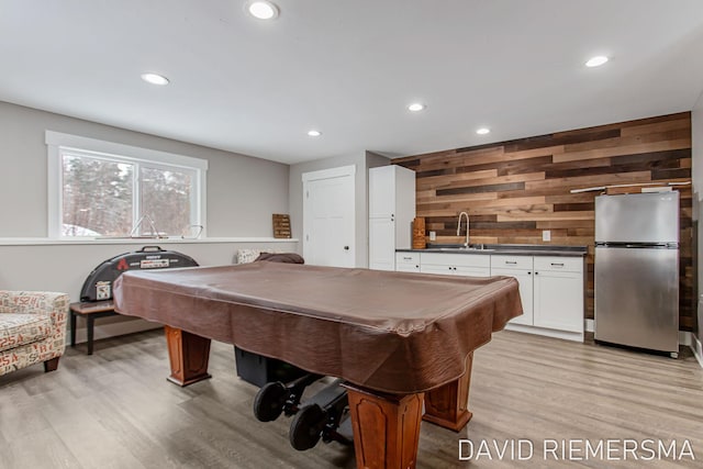 game room featuring sink, wooden walls, billiards, and light wood-type flooring