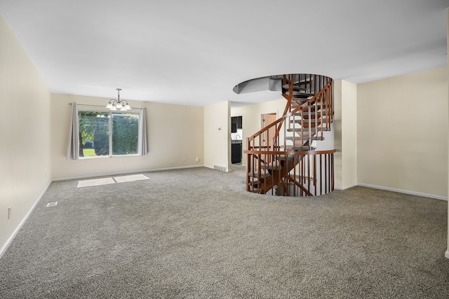 empty room with carpet and an inviting chandelier