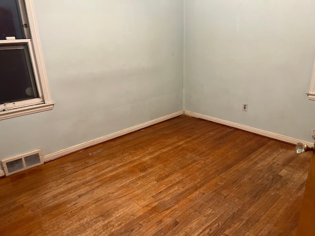 spare room featuring wood-type flooring