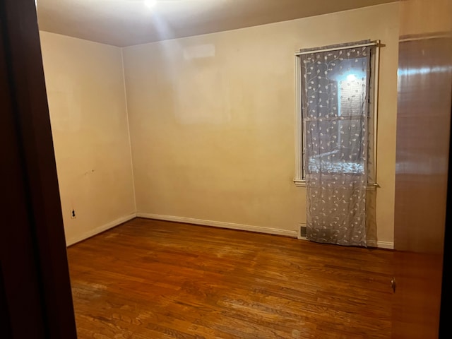 empty room featuring hardwood / wood-style flooring