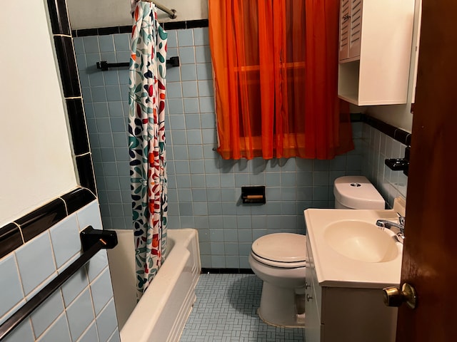 full bathroom featuring tile patterned flooring, tile walls, vanity, shower / bath combination with curtain, and toilet