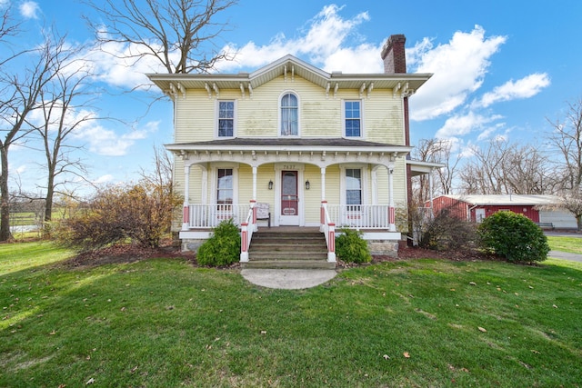 italianate-style house with a porch and a front yard