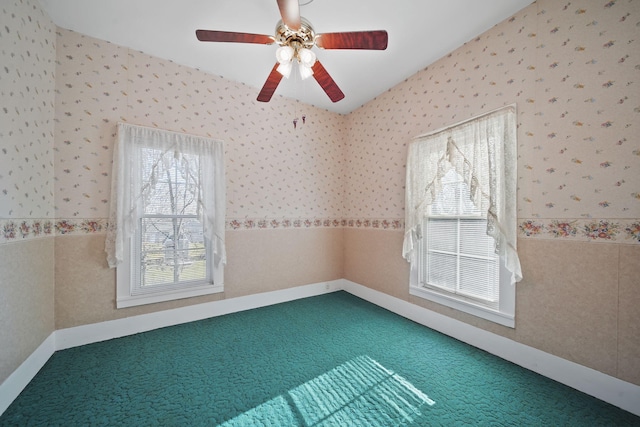 carpeted spare room with ceiling fan