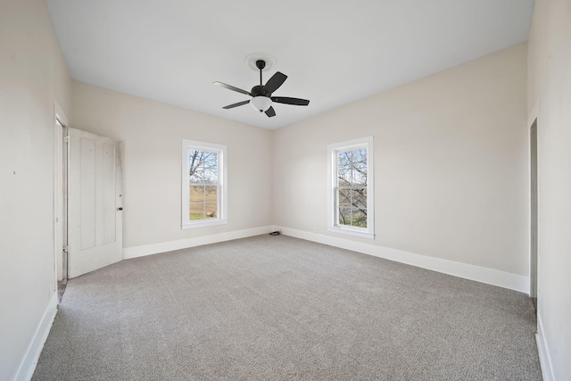 empty room with ceiling fan and carpet floors