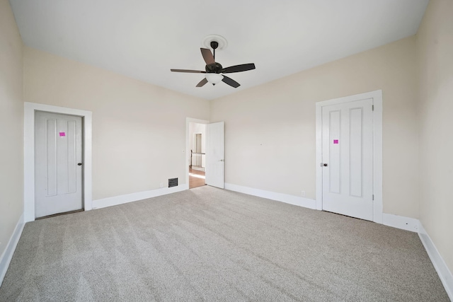 carpeted spare room with ceiling fan