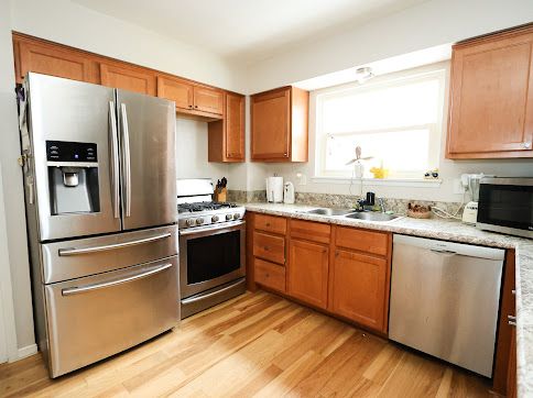 kitchen featuring light wood-type flooring, appliances with stainless steel finishes, and sink