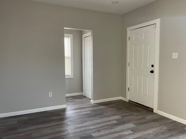 unfurnished room featuring dark hardwood / wood-style floors