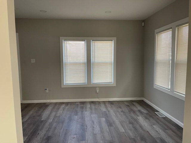 empty room with dark hardwood / wood-style flooring