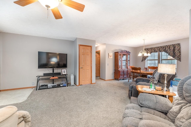 carpeted living room with a textured ceiling and ceiling fan with notable chandelier