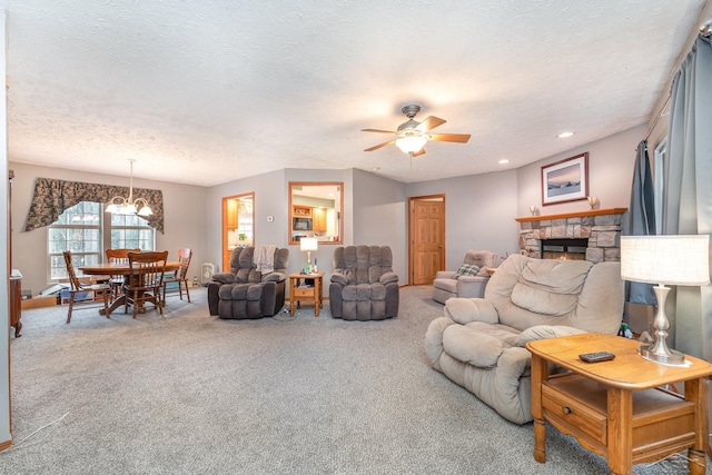 carpeted living room with a stone fireplace, ceiling fan, and a textured ceiling