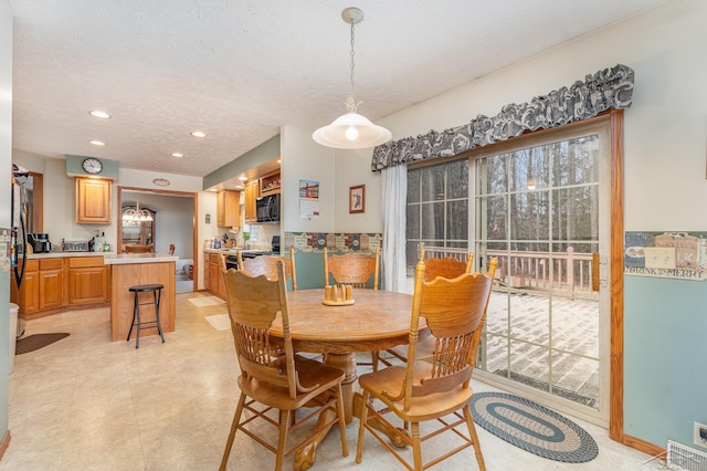 dining room with a textured ceiling