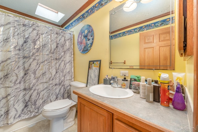 bathroom with vanity, a skylight, toilet, ornamental molding, and a textured ceiling