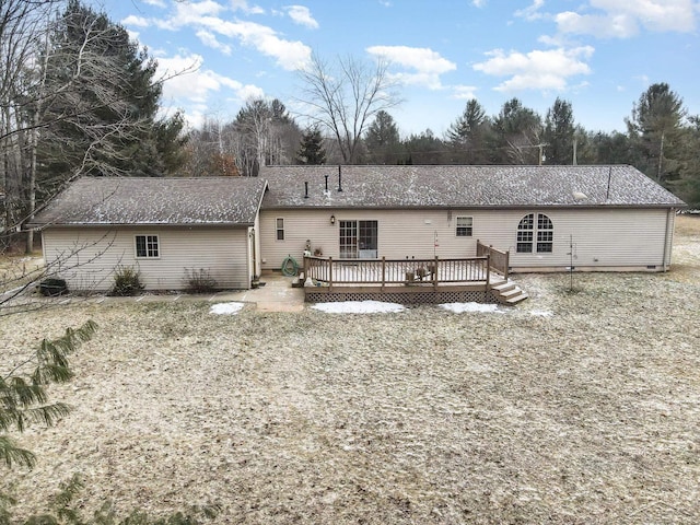 rear view of property featuring a deck