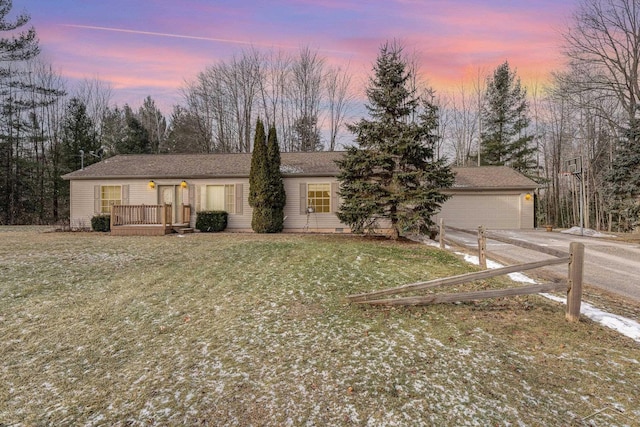 view of front of property featuring a garage and a lawn