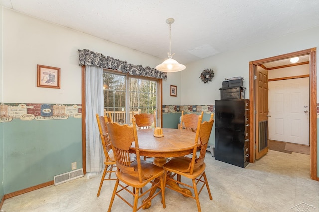 dining room featuring a textured ceiling