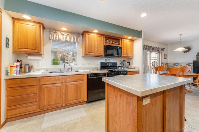 kitchen with hanging light fixtures, sink, a kitchen island, and black appliances