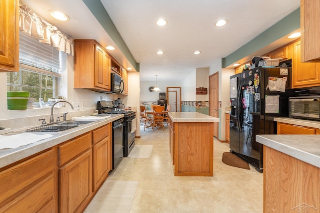 kitchen with black appliances, decorative light fixtures, a kitchen island, and sink