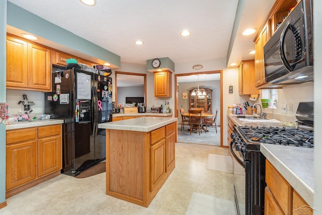 kitchen featuring black appliances, a center island, sink, and an inviting chandelier