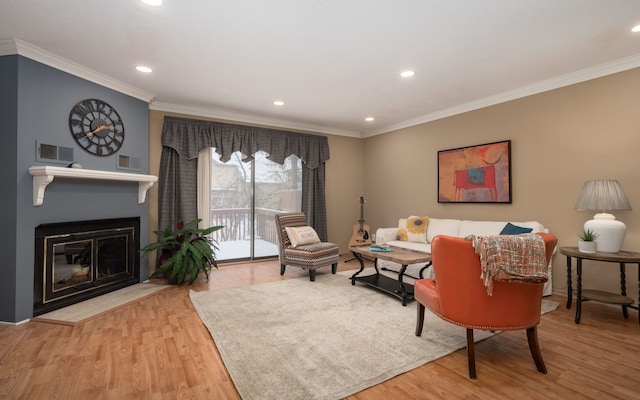 living room with hardwood / wood-style floors and ornamental molding