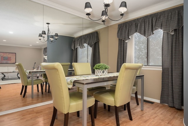 dining space featuring a chandelier, ornamental molding, and hardwood / wood-style flooring